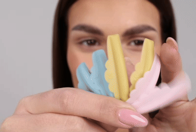Model trägt einen Silikonstab auf ihrem oberen Augenlid auf